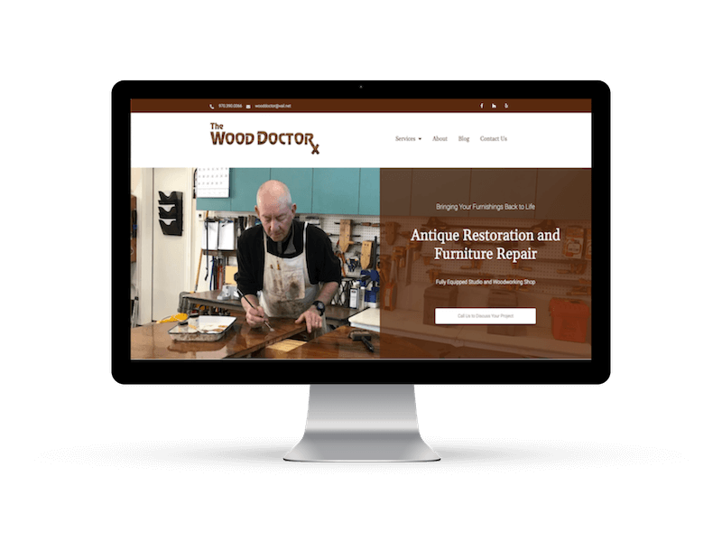 desktop computer showing The Wood Doctor home page